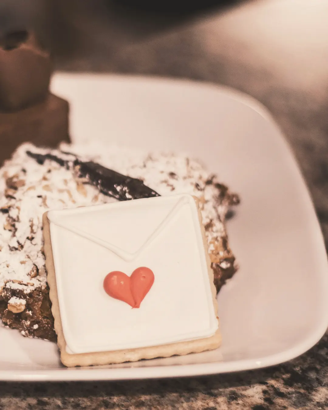 Stock photo: a dessert plate with an envelope-shaped sugar cookie decorated with a red heart