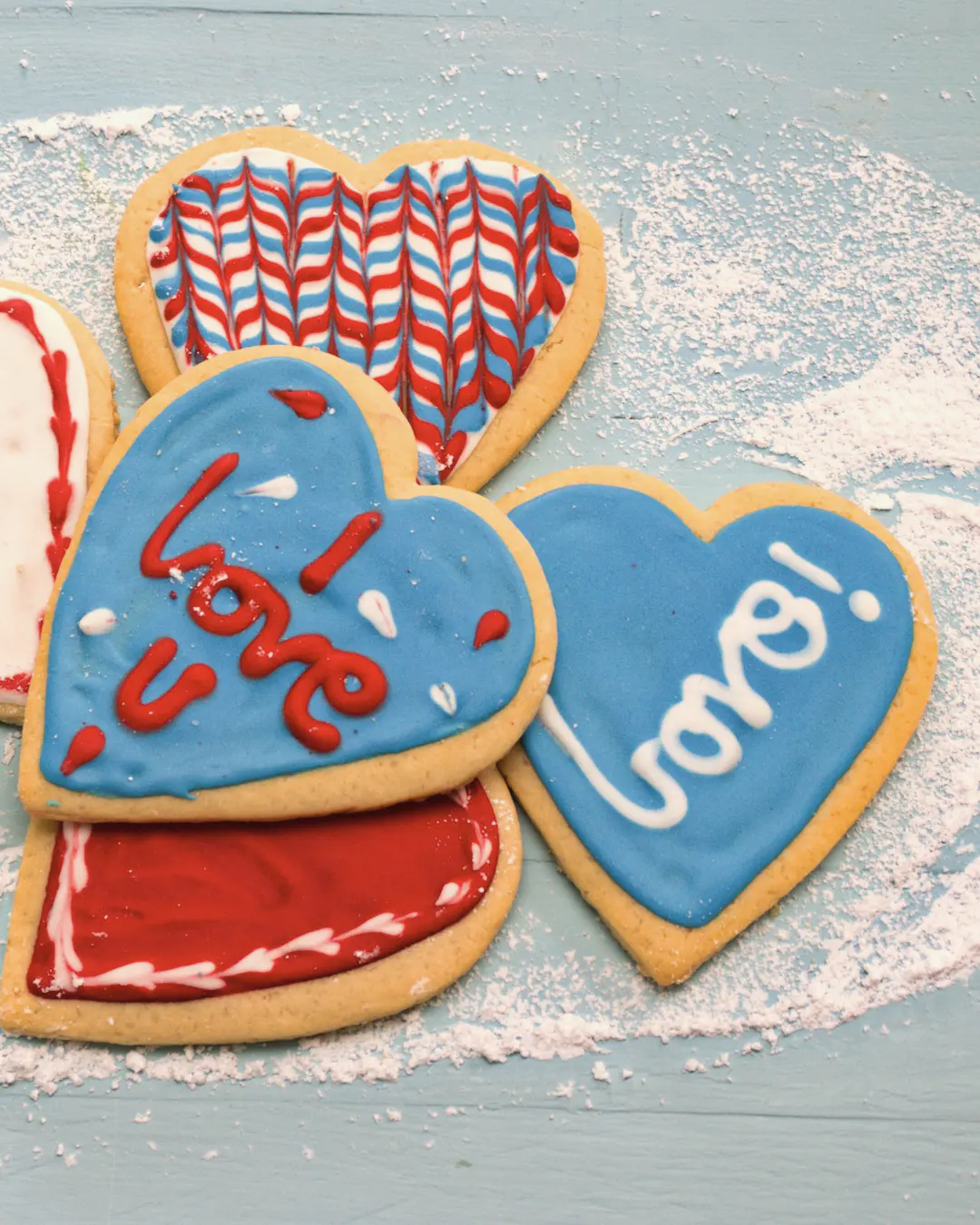 Stock photo: heart-shaped sugar cookies decorated with red, white and blue icing, one reading “I love U”