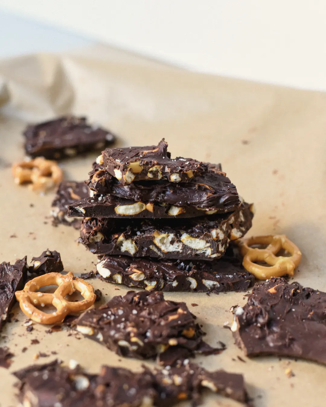 Stock photo: pieces of chocolate bark studded with pretzels, stacked on parchment paper